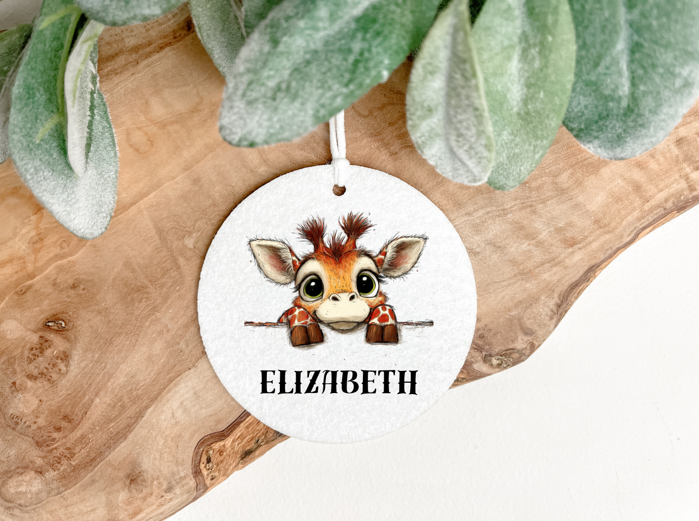 Circular Air freshener with a cartoon giraffe design anda  personalised name ,printed on both sides with a decorative ribbon