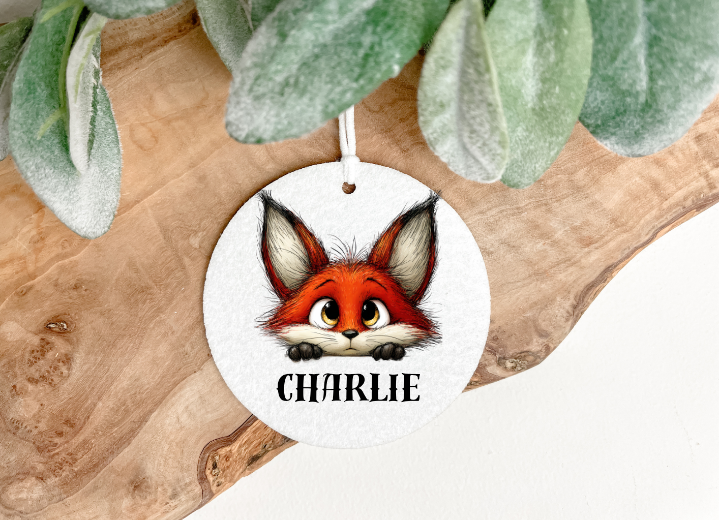 A baby fox in cartoon style printed  onto a round soft air freshener both sides 8cm diameter  with a hanging ribbon and personalised with a name ,the pet printing company