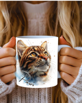 A ceramic coffee mug with a image of a beautifully etailed bengal cat looking up at its owner 110z mug with a name personalised on each side