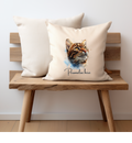 A cream cushion cover with a Bengal cat looking up printed on one side with a personalised name option, the cushion cover has a zip opening and is displayed on a small bench, the pet printing company cushion 