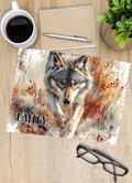 A personalised glasses cleaner printed on one side with a timber wolf running in the autumn woods